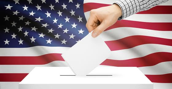 Image of a ballot being cast, with American flag in the background